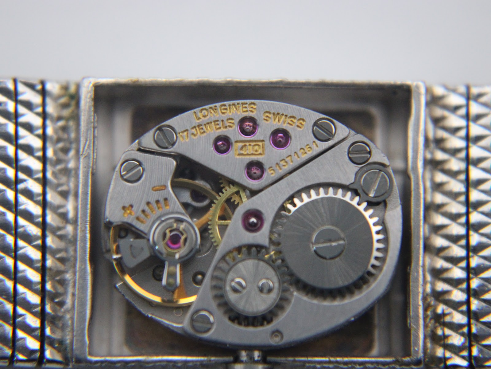 Close-up view of the Longines 410 manual wind movement with '17 jewels' and serial number '51371361'.