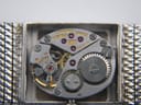 Close-up view of the Longines 410 manual wind movement with '17 jewels' and serial number '51371361'.