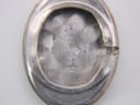 Inside view of the silver case back, showing a '925' sterling silver hallmark, 'B & Q9', and a distinct jeweller's symbol.