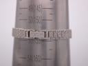 Wrist sizing gauge showing the custom-made silver bracelet measuring approximately 155mm or 15.5cm in circumference.