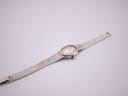 Overhead view of the full length of the Longines silver watch and its continuous textured 925 sterling silver bracelet.