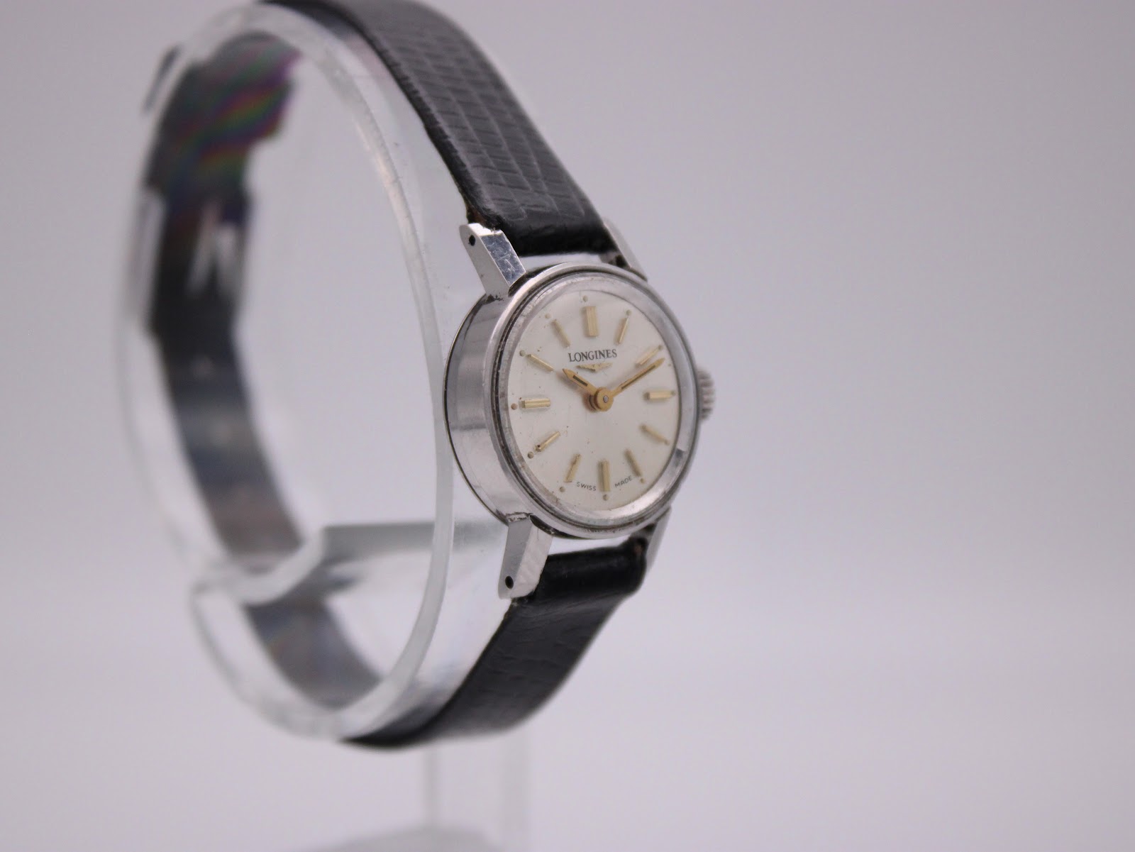 Another angled side view of the Longines 7271 vintage watch, highlighting the case and black leather strap.