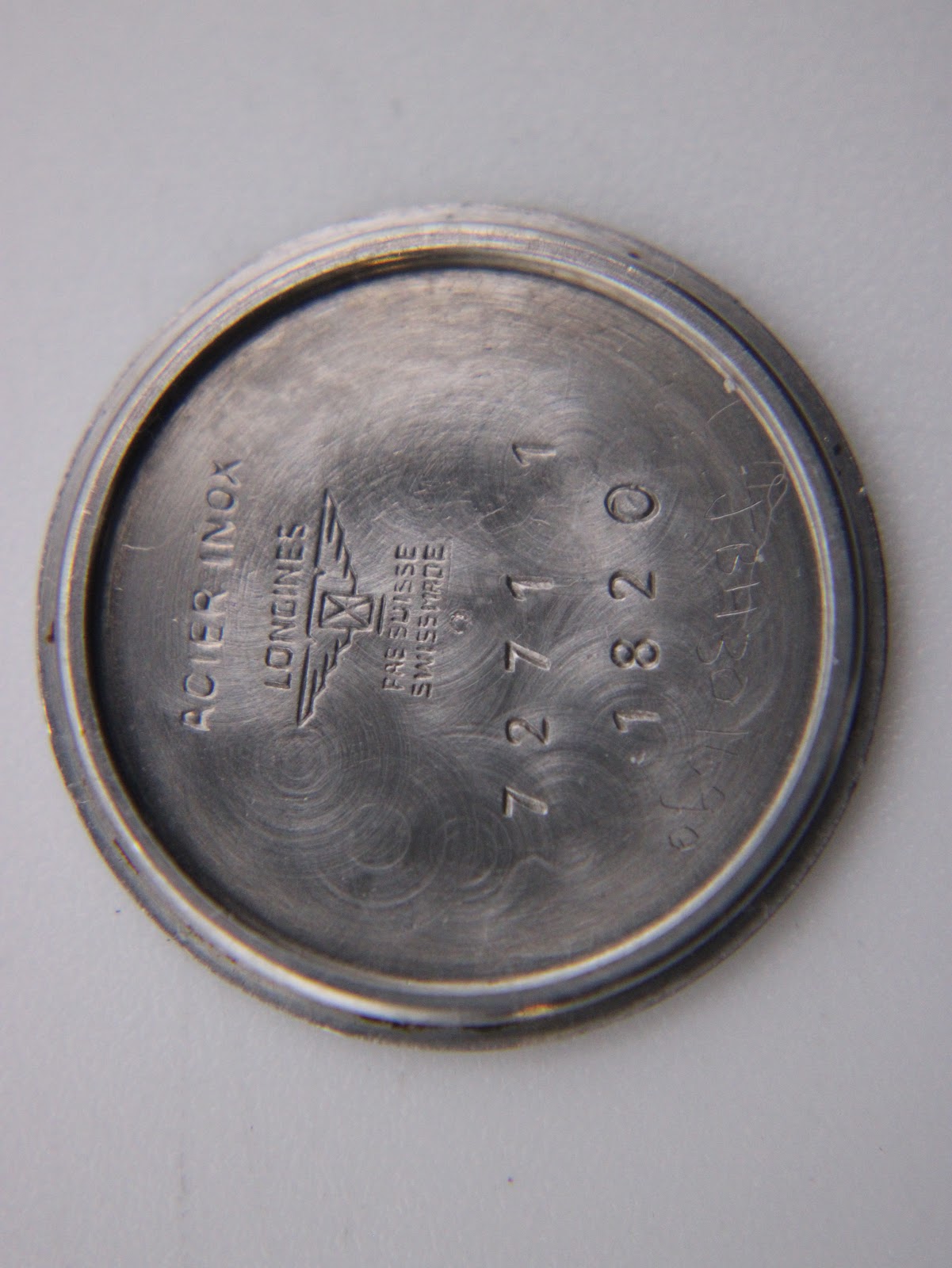 Close-up of the Longines case back, engraved with 'Acier Inox', Longines logo, 'Swiss Made', and model number 7271 and 7820.