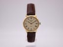 Front view of the Longines 717 1141 gold tone quartz watch with cream dial, black Roman numerals, and brown leather strap.