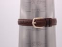 Brown leather watch strap shown on a wrist sizing gauge, indicating a wrist circumference range of approximately 15.5cm to 19.5cm.