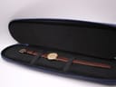 The Longines watch nestled inside its open blue original Longines travel case, showing the soft interior.