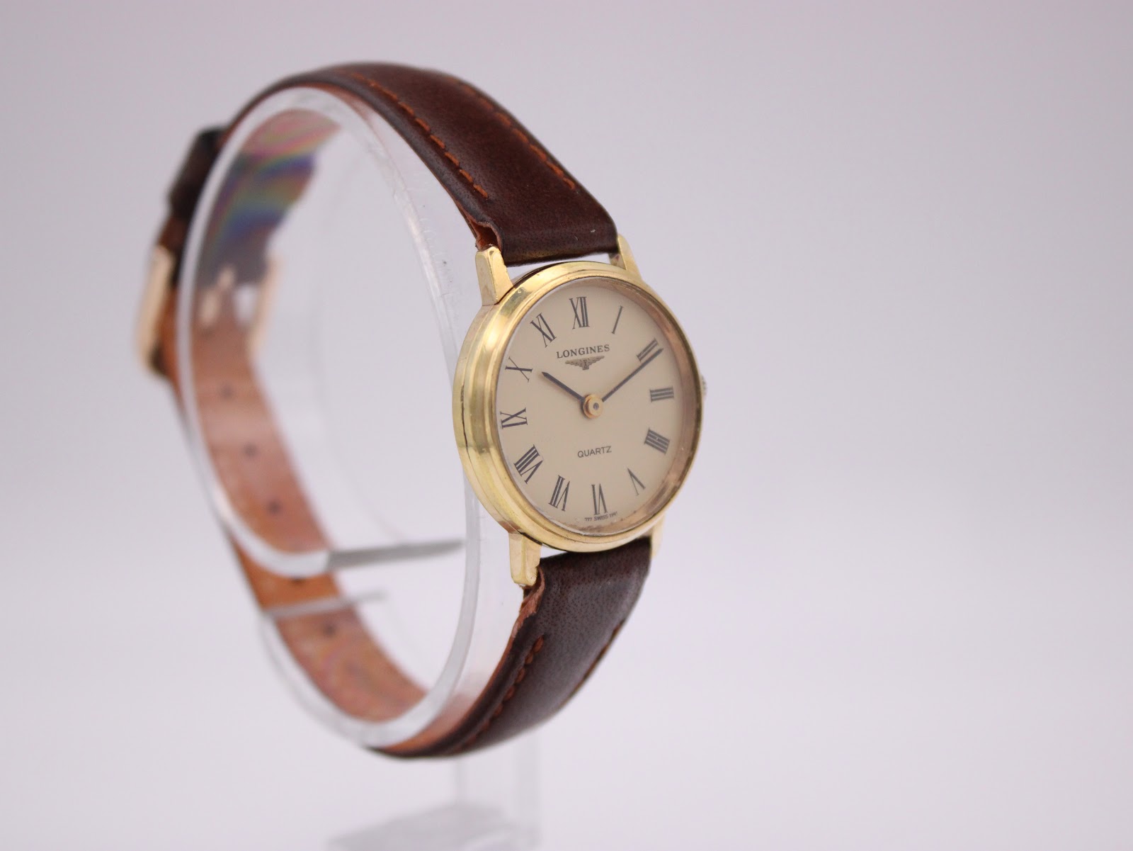 Another angled view of the Longines quartz watch, highlighting the classic cream dial and gold case.