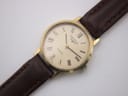 Close-up of the Longines cream dial with Roman numerals, Longines logo, 'Quartz' text, and 'Swiss Made' detail.