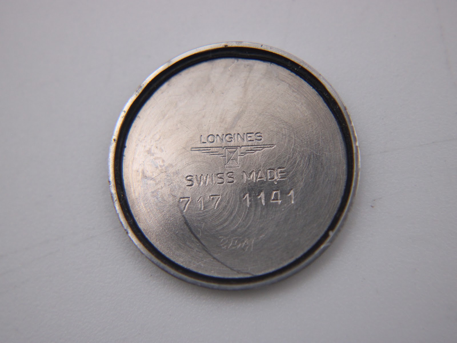 Close-up of the inner case back showing 'LONGINES SWISS MADE 717 1141' engraving.