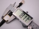 Digital caliper measuring the case diameter of the Longines watch, displaying 18.11mm.