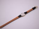 Back view of the Longines watch with its black leather strap fully extended, showing the stainless steel case back.