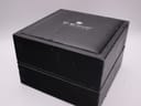 Exterior view of the original black TAG Heuer watch box, showing signs of wear.