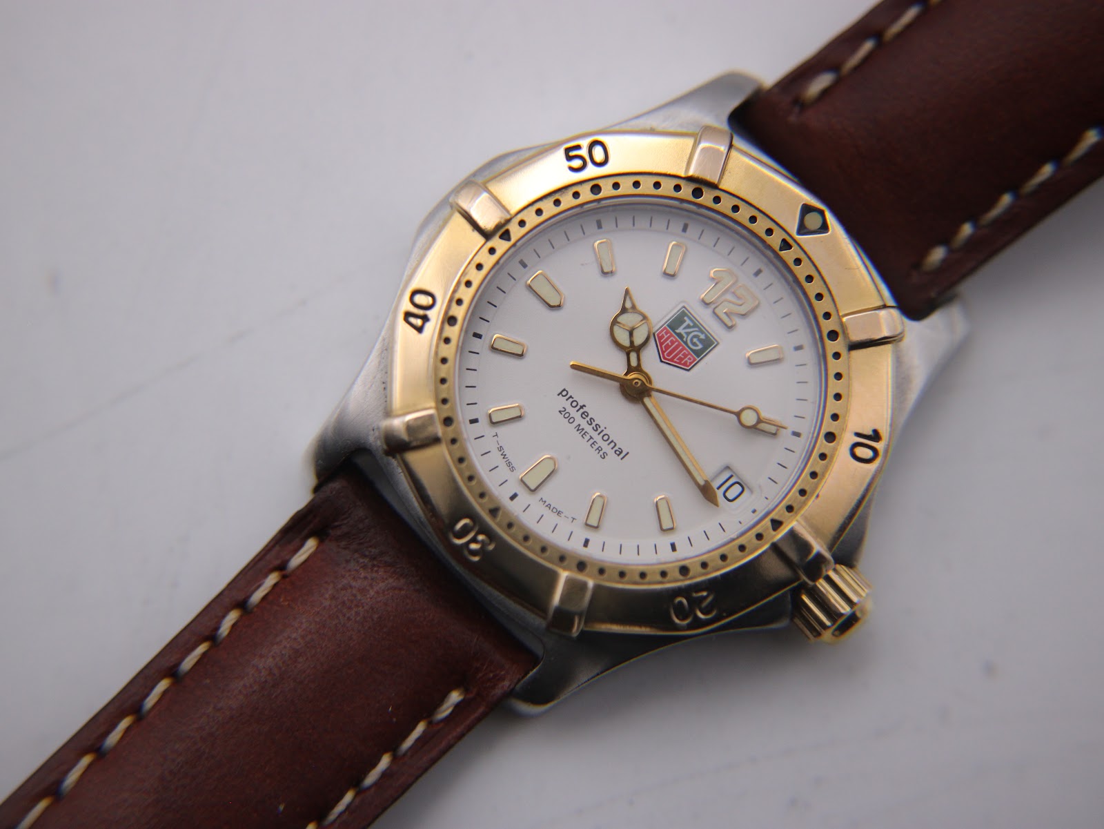 Close-up of the watch dial, revealing the TAG Heuer logo, "Professional 200 METERS" text, and date window.
