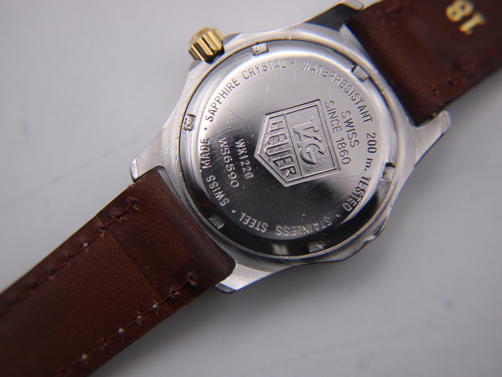 Detailed view of the watch case back, with engravings including "WK1220", "WS590", "Sapphire Crystal", and "200 m Waterresistant".