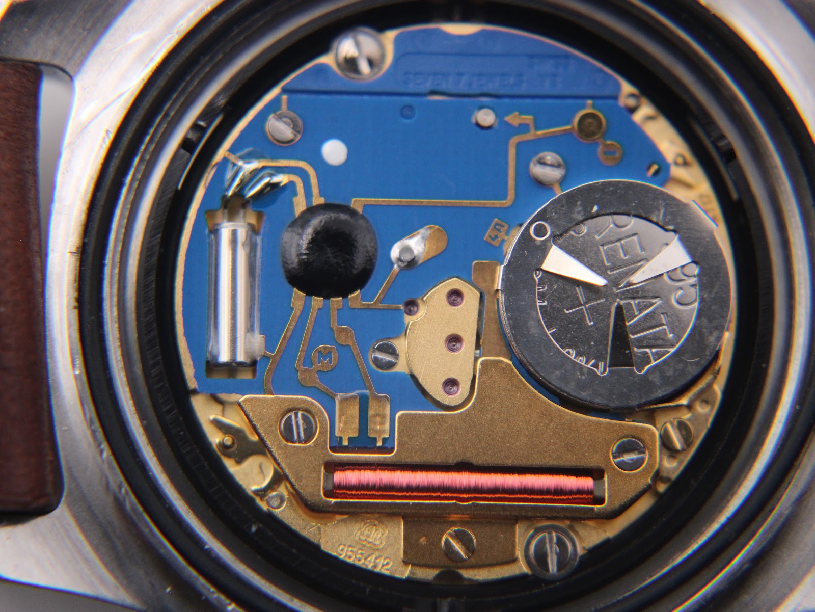 Close-up of the quartz movement visible inside the opened case of the TAG Heuer watch.