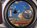 Close-up of the quartz movement visible inside the opened case of the TAG Heuer watch.