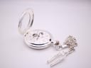 Open view of the silver-plated Heritage Collection pocket watch with its matching chain and T-bar fob, on a white surface.