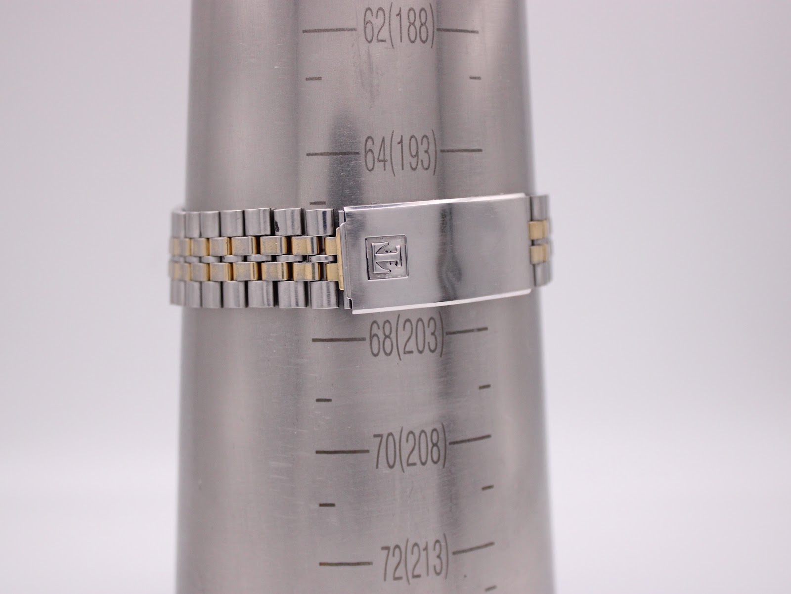 The Tissot PR 100 bracelet on a wrist sizing cone, indicating a maximum wrist circumference of approximately 19.8cm.
