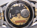 Open case back revealing the Swiss quartz movement with "SEVEN 7 JEWELS SWISS V8" inscription and Renata battery.