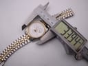 Top-down view of the watch being measured by digital calipers, showing a case size of 33.94mm.