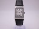 Front view of the Tissot Z173K rectangular watch with a white dial and black leather strap on a watch stand.