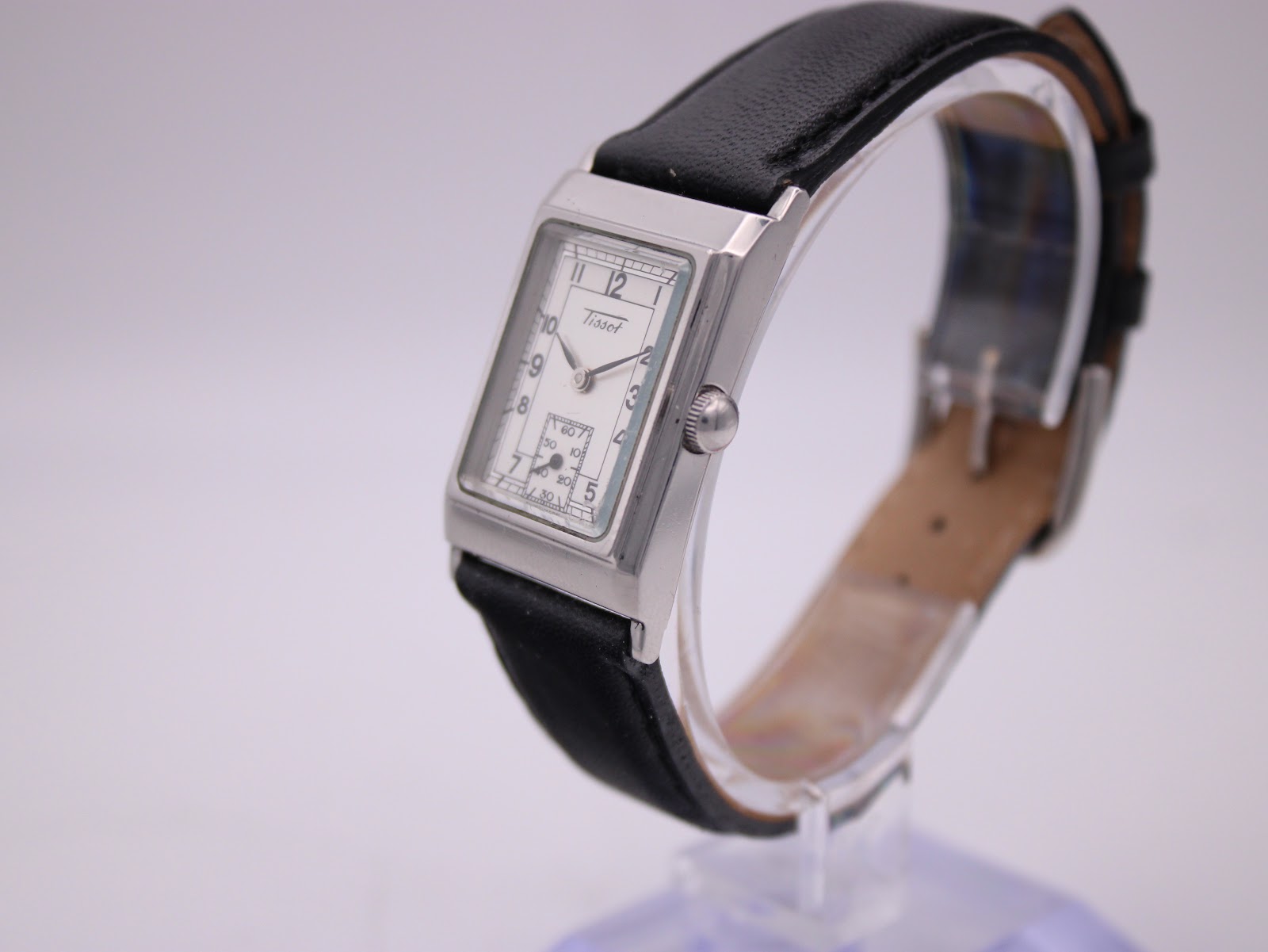 Angled side view of the Tissot Z173K watch showing the polished stainless steel case and crown.