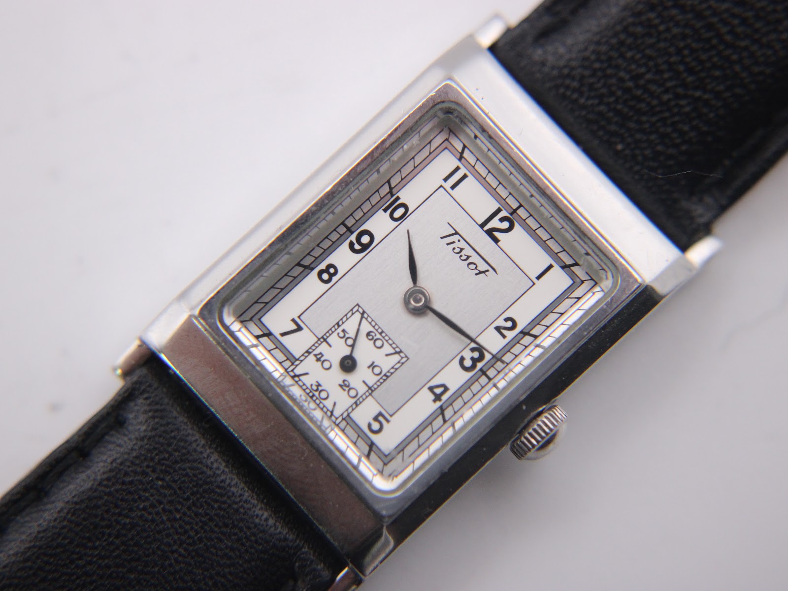 Close-up of the Tissot Z173K's white rectangular dial with black Arabic numerals and a small seconds sub-dial.