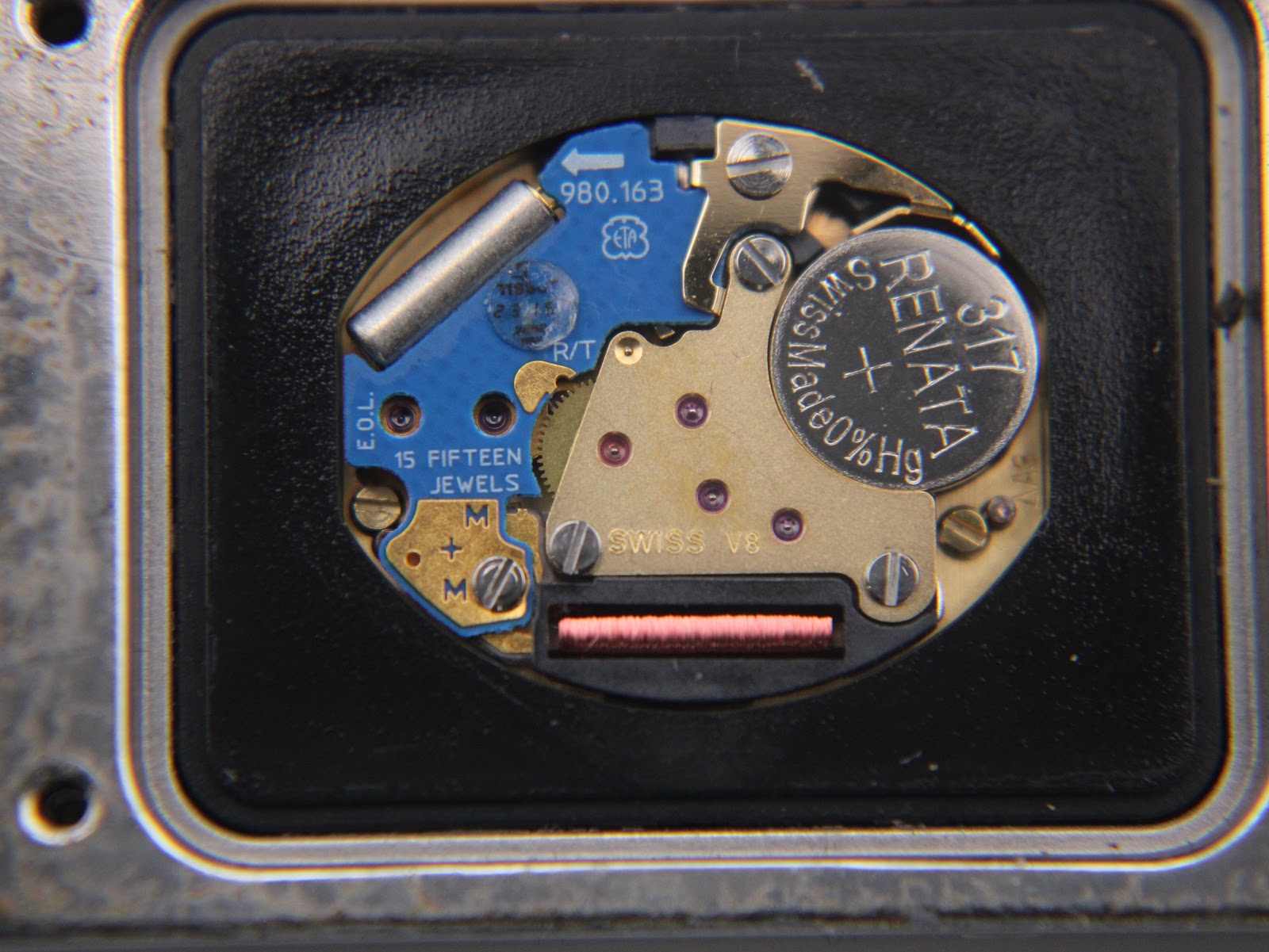 Macro shot of the Tissot quartz movement, showing ETA 980.163 calibre, 15 jewels, and a Renata battery.