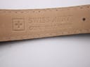 Detail shot of the genuine leather strap's underside, displaying the 'Swiss Made' cross logo and 'Genuine Leather' imprint.