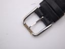 Close-up of the watch's buckle, clearly showing the 'TISSOT' brand name engraved.