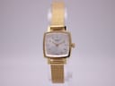 Front view of the Tissot T058109 A ladies' gold-tone square watch with silver dial on a display stand.