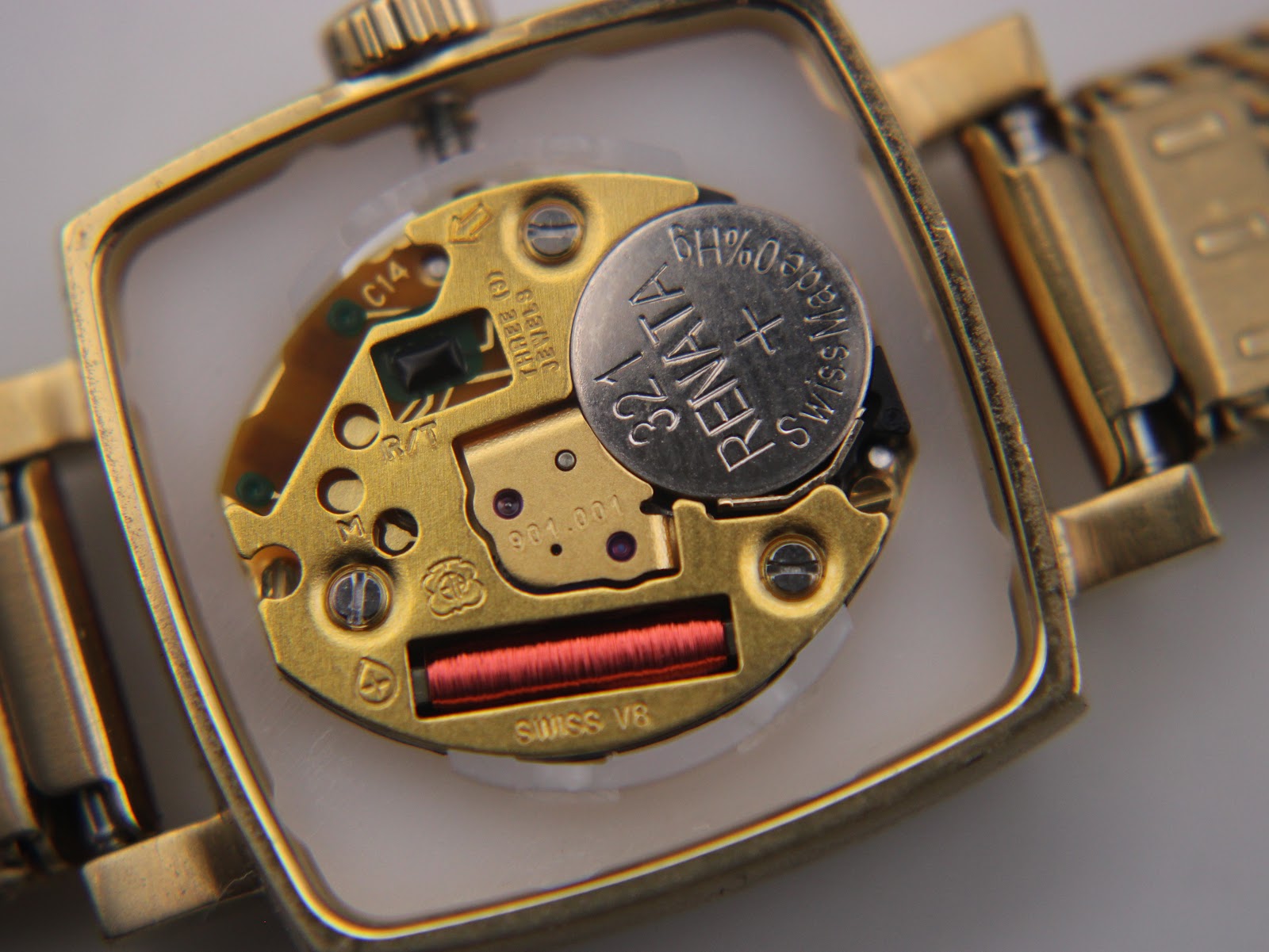 Macro view of the watch's Swiss quartz movement with a Renata battery visible, inside the open case.