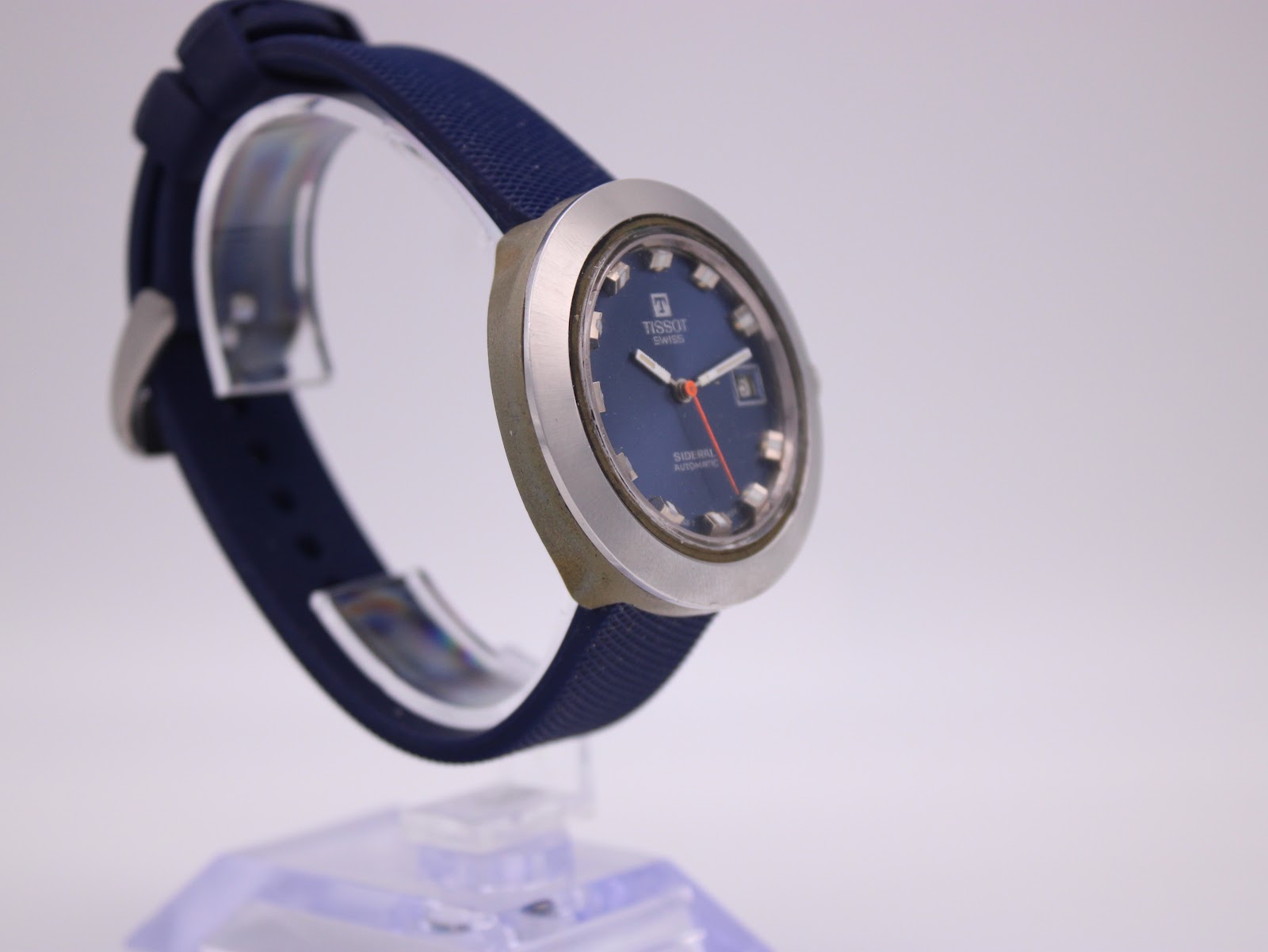 Another angled side view of the watch, showing the crown side and the profile of the case and strap.