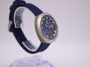 Another angled side view of the watch, showing the crown side and the profile of the case and strap.