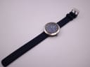 Overhead view of the entire Tissot Sideral watch laid flat, displaying the full navy rubber strap and buckle.