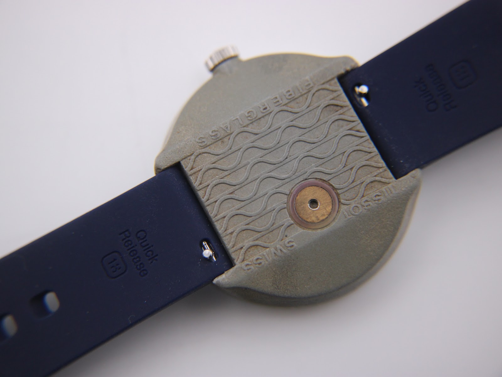 Detailed close-up of the Tissot Sideral's fibreglass case back with 'FIBERGLASS' and 'SWISS' engravings, and the 18mm quick release strap.