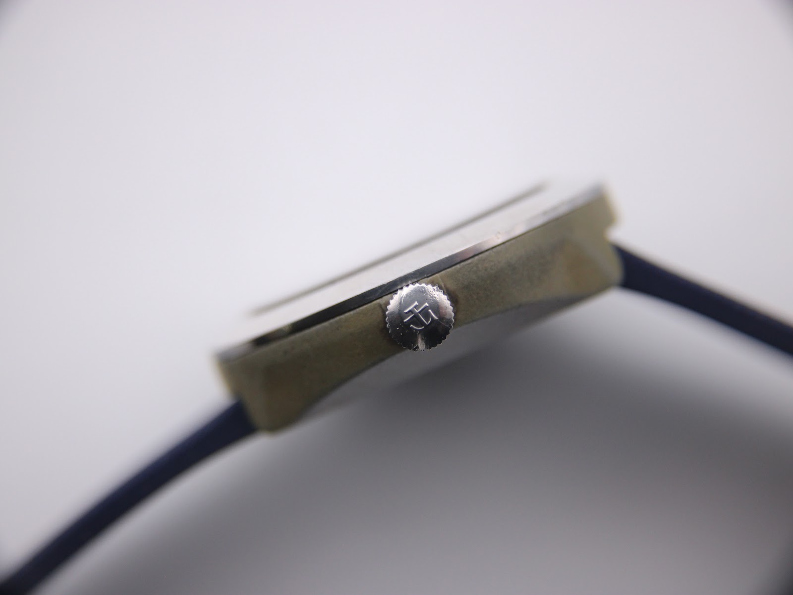 Close-up of the Tissot Sideral's crown, featuring the iconic Tissot 'T' logo.
