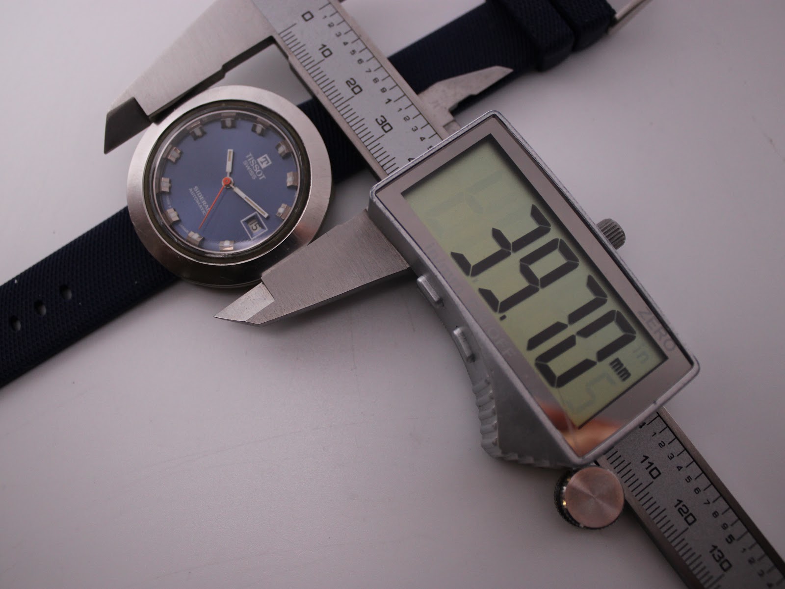 Digital caliper measuring the Tissot Sideral case, displaying an exact measurement of 39.70mm.