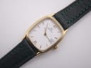 Close-up of the Zenith watch's white dial with gold Roman numerals and baton indices, date window, and "SWISS MADE" text.