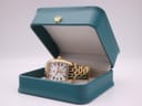 The Michele Mini Urban watch resting inside its original teal-coloured presentation box with a gold crown emblem.