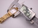 Digital caliper measuring the case diameter of the gold-tone Michele watch, displaying 29.37mm.