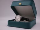 The Eterna watch nestled inside its original dark green presentation box with a gold crown emblem.
