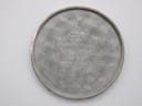 Close-up of a brushed silver-tone watch case back with various engravings: "OMEGA WATCH Co", "FAB. SUISSE", "SWISS MADE", "ACIER INOXYDABLE", and "511.215".