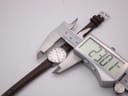 A round watch with a white dial and brown leather strap is held by digital callipers, which display a measurement of "23.07 mm".