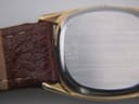 Close-up of the brushed stainless steel case back of the Omega De Ville, with "QUARTZ 1337" engraving.