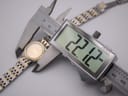 Digital caliper measuring the Omega watch case diameter at 22.12mm.