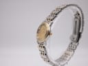 Angled side view of the Omega watch on a display stand, highlighting the two-tone case and bracelet.