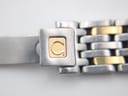 Close-up of the two-tone bracelet's signed folding clasp, featuring the Omega logo in gold.
