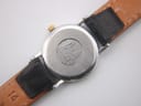 Close-up of the brushed stainless steel case back of the Omega De Ville, showing the embossed logo and serial number.