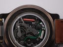 Extreme close-up view of the internal quartz movement with the battery visible, marked 'RENATA SWISS'.